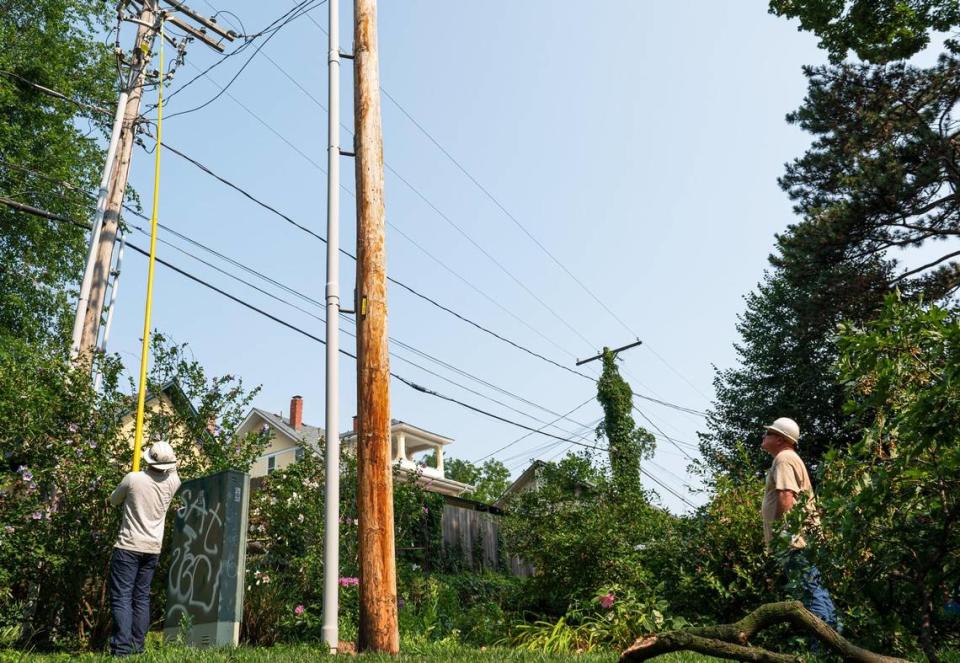 Evergy workers continued to restore power to residents in the Hyde Park neighborhood on Saturday, July 15, 2023, in Kansas City. More than 92,000 residents were without power on Saturday morning.