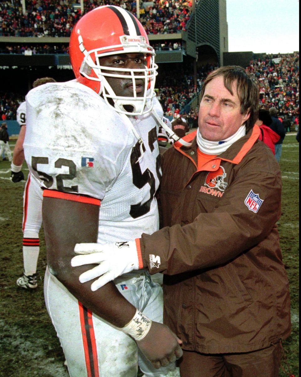 Browns head coach Bill Belichick congratulates linebacker Pepper Johnson after a 26-10 win over the Cincinnati Bengals on Sunday, Dec. 17, 1995, in Cleveland Stadium.