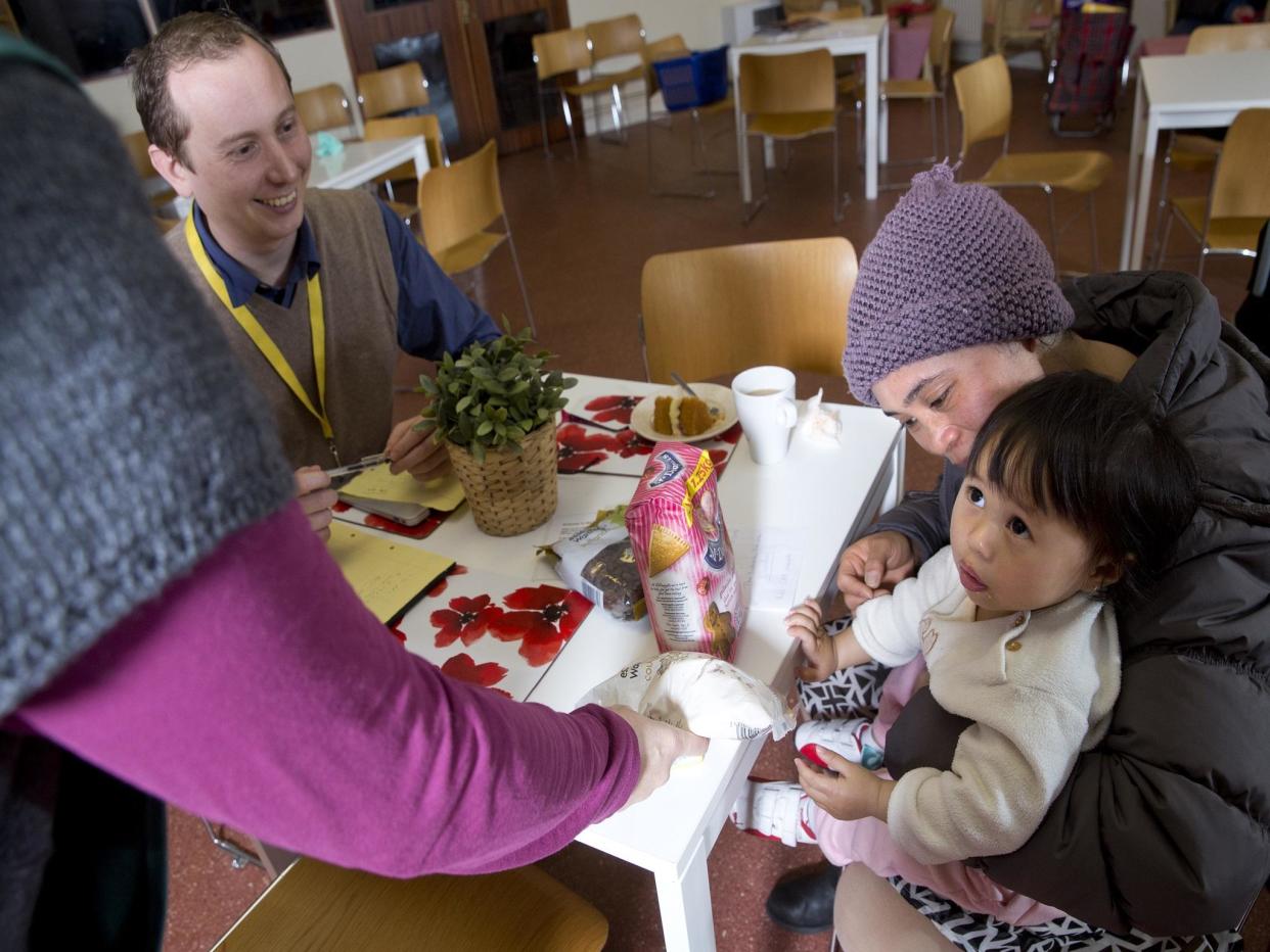 One family at Hammersmith and Fulham food bank that relies on the service to eat since falling into debt after their benefits were paid late: Teri Pengilley/The Independent