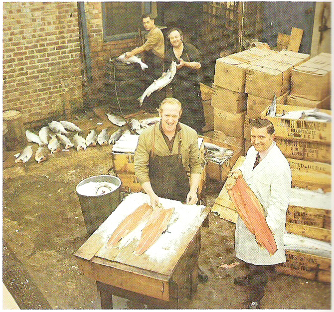 In this 1960 photo provided by H. Forman & Son, Marcel Forman, right, Lance Forman's father in the salmon curing yard in London. Forman's family has been producing traditional smoked salmon in London for four generations and supply so of London's finest restaurants, hotel and stores. (H. Forman & Son via AP)