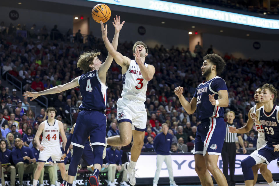 Saint Mary's guard Augustas Marciulionis (3) shoots between Gonzaga guard Dusty Stromer (4) and forward Anton Watson (22) during the first half of an NCAA college basketball game in the championship of the West Coast Conference tournament Tuesday, March 12, 2024, in Las Vegas. (AP Photo/Ian Maule)