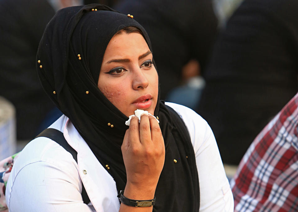 In this Tuesday, Sept. 18, 2018 photo, Hajar Youssif, an Iraqi activist and volunteer medic, who was kidnapped, beaten and threatened for attending protests, sits with protesters in Basra, Iraq. Youssif said the beating left her shaken and that threats continue, but she won’t be deterred. Activists say powerful Iranian-backed militias that control Iraq’s oil capital of Basra have waged a campaign of intimidation and arbitrary arrests to silence protests aimed at poor government services and Tehran’s outsized influence in the region. (AP Photo/Nabil al-Jurani)