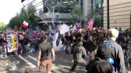 Protesters of the right-wing group Patriot Prayer clash with protesters from anti-fascist groups during a demonstration in Portland, Oregon, U.S. June 30, 2018, in this still image taken from video from obtained from social media. Bryan Colombo/via REUTERS