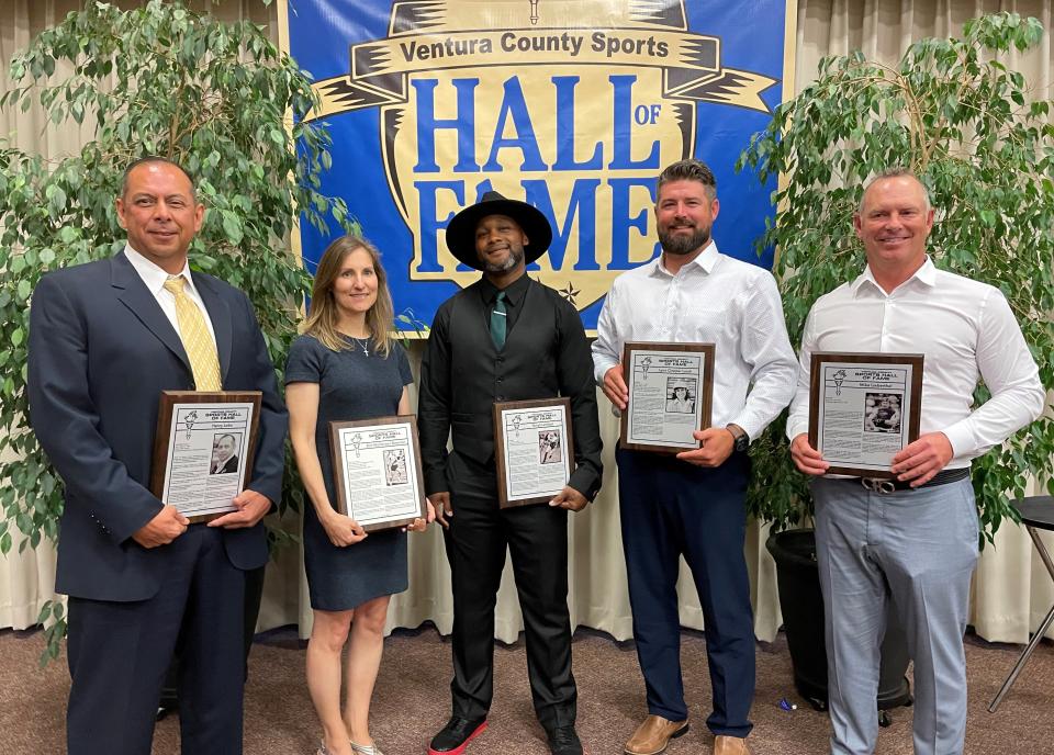 Henry Lobo (left to right), Kim Mortensen Newman,
Terrail Lambert, Ryan Clopper (accepting the honor for his late mother Lynn Clopper Losch), and Mike Lieberthal pose with their plaques after being inducted into the Ventura County Sports Hall of Fame during a ceremony Sunday night at the Serra Center in Camarillo.