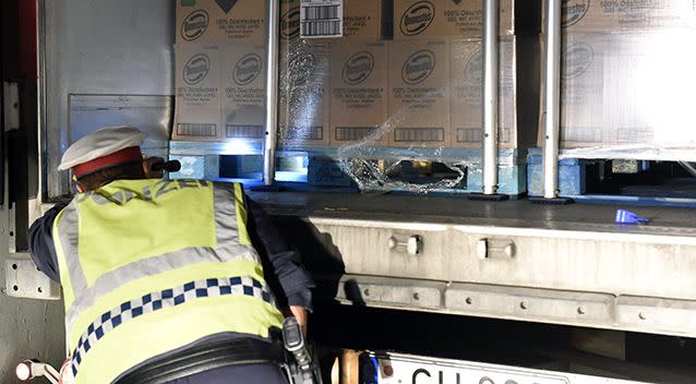 Austrian Police officers search a truck as they patrol on the motorway near the Austro-Hungarian border. Source: AAP