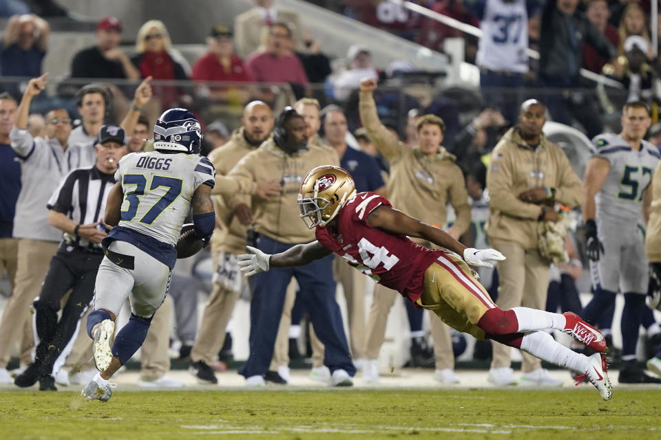 Seattle Seahawks defensive back Quandre Diggs (37) runs after intercepting a pass against San Francisco 49ers wide receiver Kendrick Bourne (84) during the second half of an NFL football game in Santa Clara, Calif., Monday, Nov. 11, 2019. (AP Photo/Tony Avelar)
