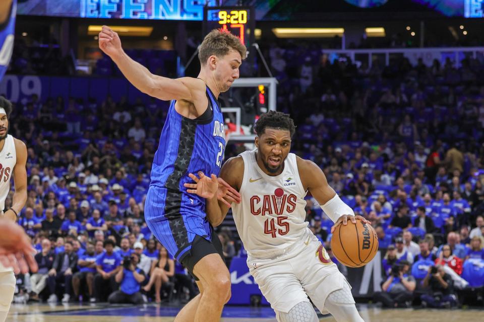 Cleveland Cavaliers guard Donovan Mitchell (45) drives around Orlando Magic forward Franz Wagner (22) during Game 3.