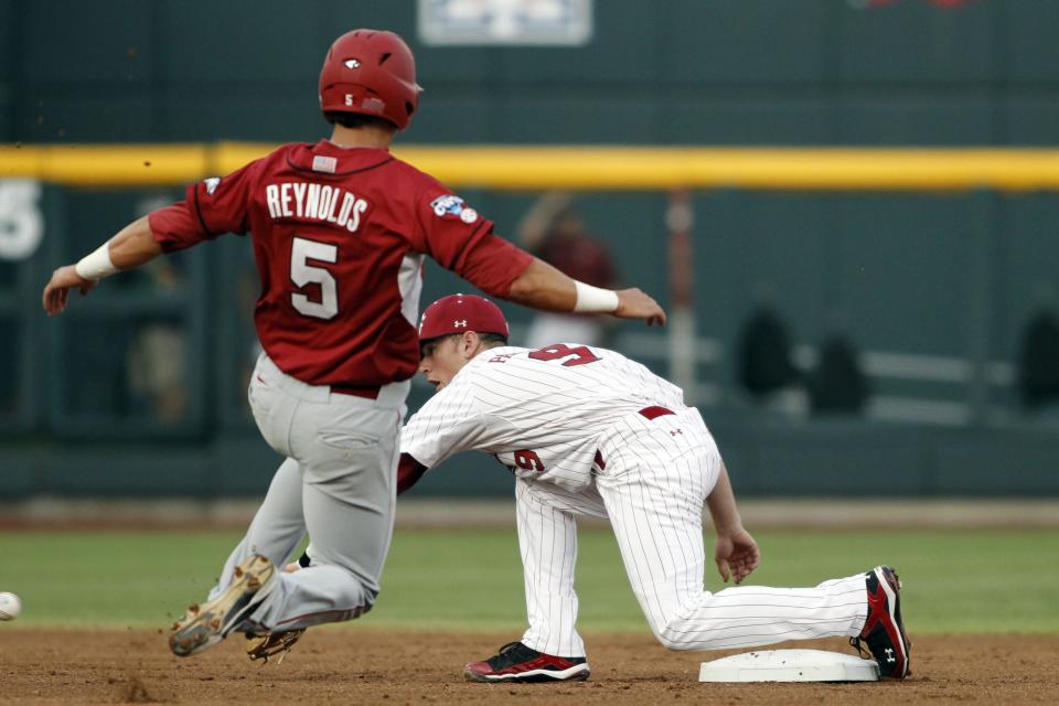 Jun 22, 2012; Omaha, NE, USA; Arkansas Razorbacks third baseman Matt Reynolds (5) steals second base ahead of the tag by <a class="link " href="https://sports.yahoo.com/ncaaw/teams/south-carolina/" data-i13n="sec:content-canvas;subsec:anchor_text;elm:context_link" data-ylk="slk:South Carolina;sec:content-canvas;subsec:anchor_text;elm:context_link;itc:0">South Carolina</a> Gamecoks short stop Joey Pankake (9) during the first inning during game thirteen of the 2012 College World Series at TD Ameritrade Park. Mandatory Credit: Matt Ryerson-USA TODAY Sports