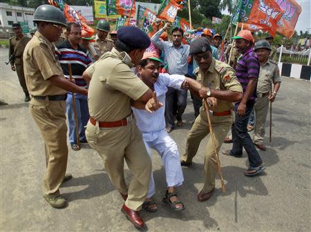 A supporter of India's main opposition Bharatiya Janata Party (BJP) shouts slogans as he is detained by police during a 12-hour strike in Agartala, capital of India's northeastern state of Tripura, May 12, 2014. REUTERS/Jayanta Dey