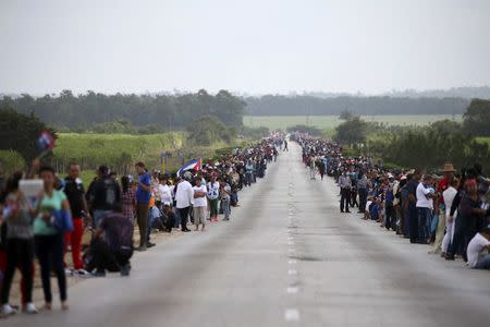 People line a road as they await the caravan carrying Cuba's late President Fidel Castro's ashes in El Maja, Cuba, December 1, 2016. REUTERS/Carlos Garcia Rawlins