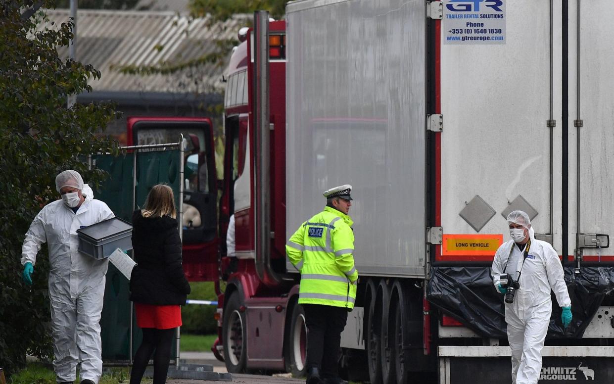 British Police forensics officers work on lorry, found to be containing 39 dead bodies, at Waterglade Industrial Park in Grays, east of London - BEN STANSALL /AFP