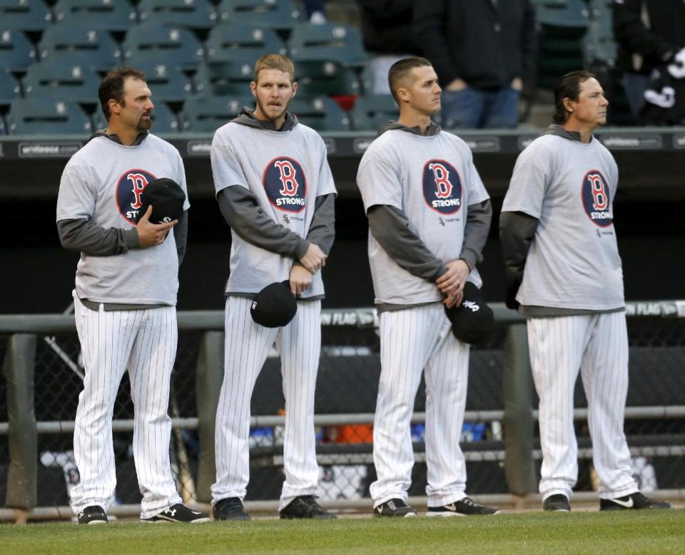 Members of the Chicago White Sox, from left, Paul Konerko, Chris Sale, Nate Jones, and Scott Downs stand wearing Boston Strong shirts before the White Sox's baseball game against the Boston Red Sox on Tuesday, April 15, 2014, in Chicago. (AP Photo/Charles Rex Arbogast)