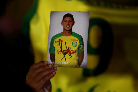 A fan holds a portrait of Emiliano Sala in Nantes' city center after news that newly-signed Cardiff City soccer player Emiliano Sala was missing after the light aircraft he was travelling in disappeared between France and England the previous evening, according to France's civil aviation authority, France, January 22, 2019. REUTERS/Stephane Mahe