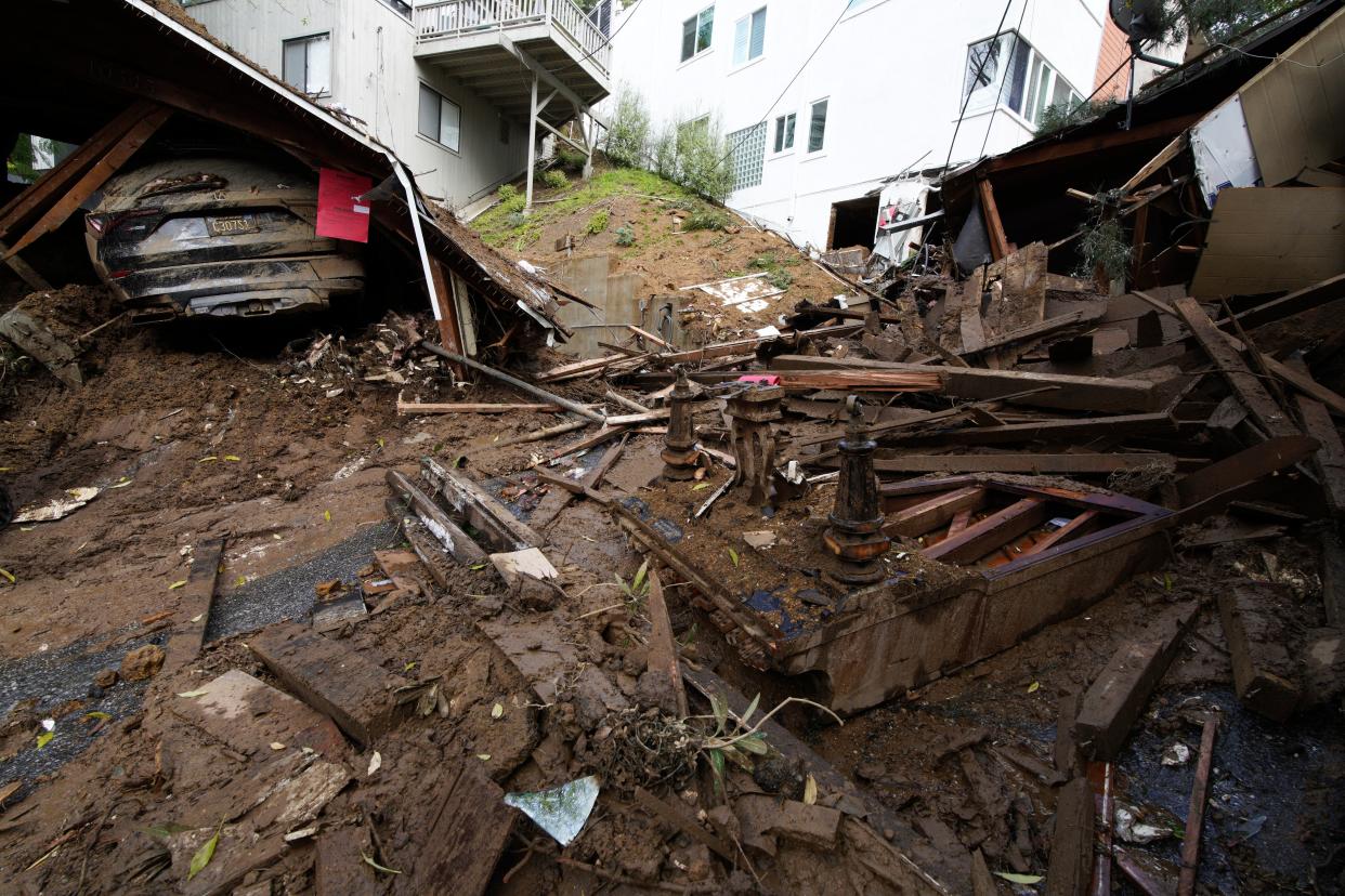 The remains of a piano and a collapsed carport are what's left of a house demolished by mud flows caused by heavy rains in the Beverly Glen section of Los Angeles (Copyright 2024 The Associated Press. All rights reserved.)