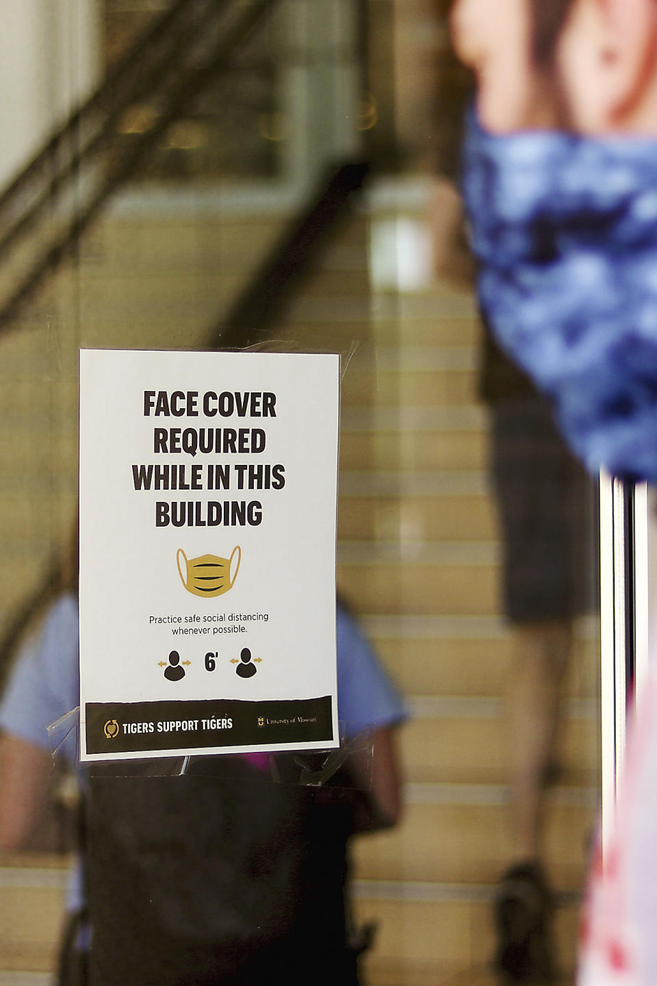 A student wearing a face mask to protect against the coronavirus enters the Student Center on Aug. 19, 2020, at the University of Missouri in Columbia, Mo. As waves of schools and businesses around the country are cleared to reopen, college towns are moving toward renewed shutdowns because of too many parties and too many COVID-19 infections among students. (Owen Ziliak/Missourian via AP)