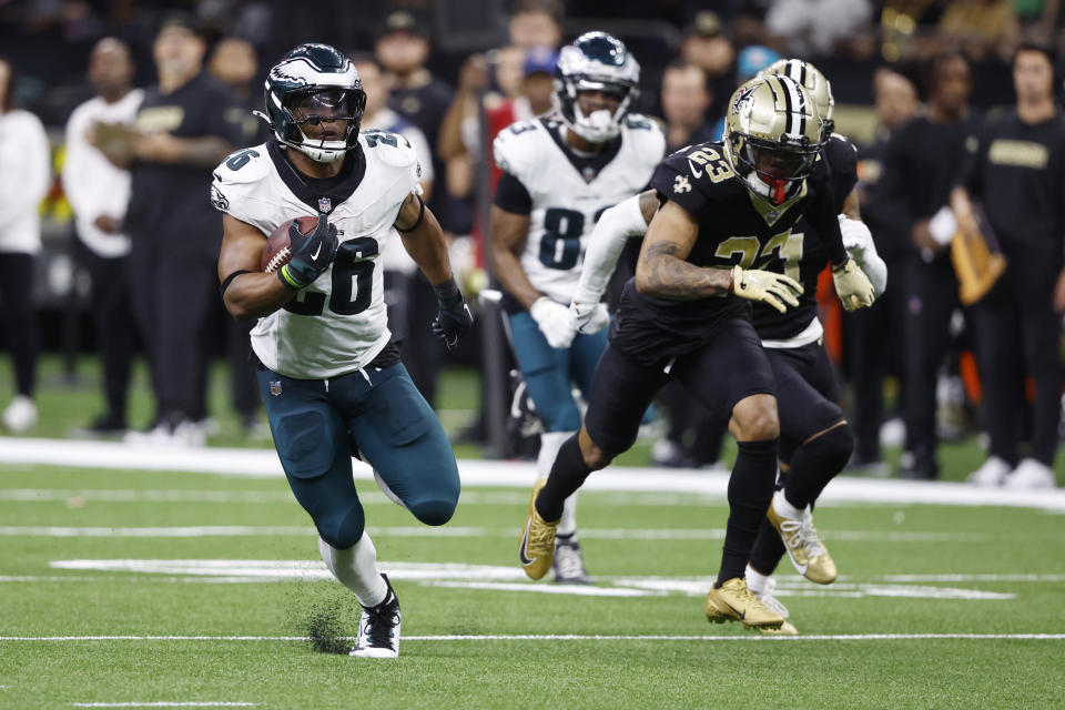 Philadelphia Eagles running back Saquon Barkley (26) runs 65 yards for a touchdown as New Orleans Saints cornerback Marshon Lattimore (23) gives chase in the second half of an NFL football game in New Orleans, Sunday, Sept. 22, 2024. (AP Photo/Butch Dill)