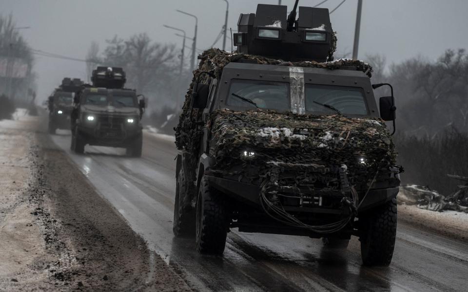 Armoured personnel carriers ride on a road near a frontline in Donetsk - VIACHESLAV RATYNSKYI/REUTERS