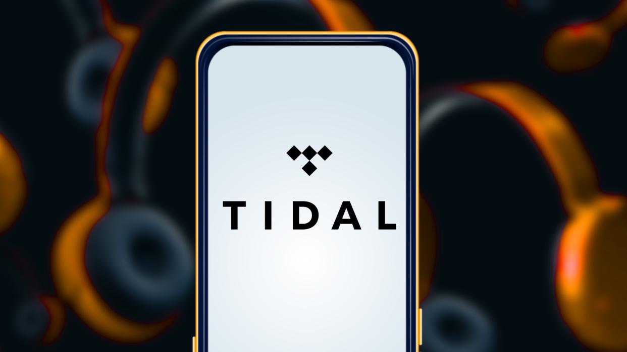  Tidal logo on phone with headphones in the background. 