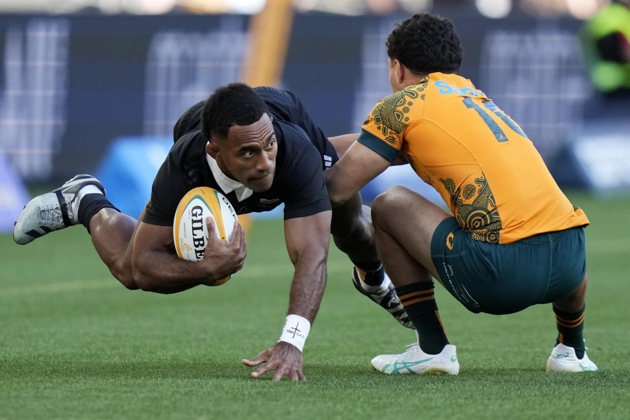 New Zealand's Sevu Reece, left, is tackled by Australia's Noah Lolesio during their rugby union test match in Sydney, Saturday, Sept. 21, 2024. (AP Photo/Rick Rycroft)