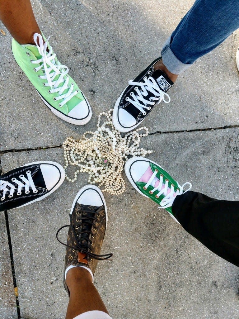 Kamala Harris' sorority sisters from Alpha Kappa Alpha wear their Chuck Taylor sneakers in solidarity with Harris on the day of her inauguration as vice president. Pearls are also a staple of the sorority, as are the colors salmon-pink and apple-green. Curry Park in Lake Worth, Florida on Jan. 20, 2021.
