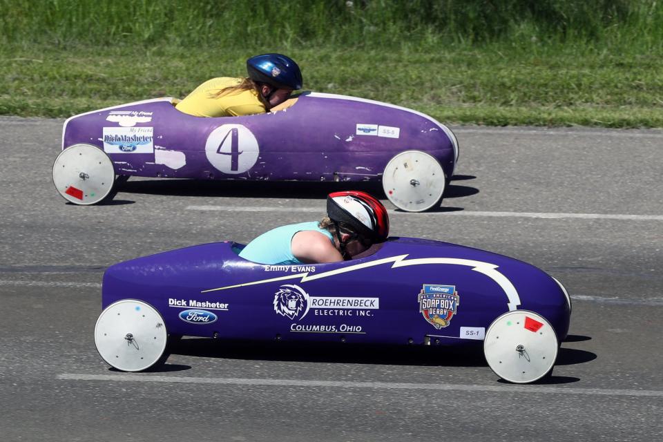 Emmy Evans (bottom) of Dublin and Morgan Davis of Pickerington compete in a superstock division race May 14 at the Columbus Area Championships of the Columbus Soap Box Derby on May 14 at Big Run Park in Columbus. Winners in each division, stock, superstock and masters, move on to compete in the All-American Soap Box Derby World Championships on July 23 in Akron.