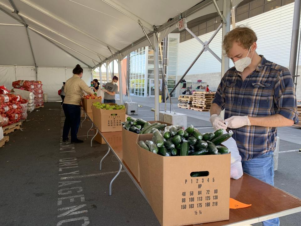 Volunteers at the San Francisco-Marin Food Bank fill bags of fruit and produce for people who are food insecure. The food bank has seen need increase during the COVID-19 emergency.