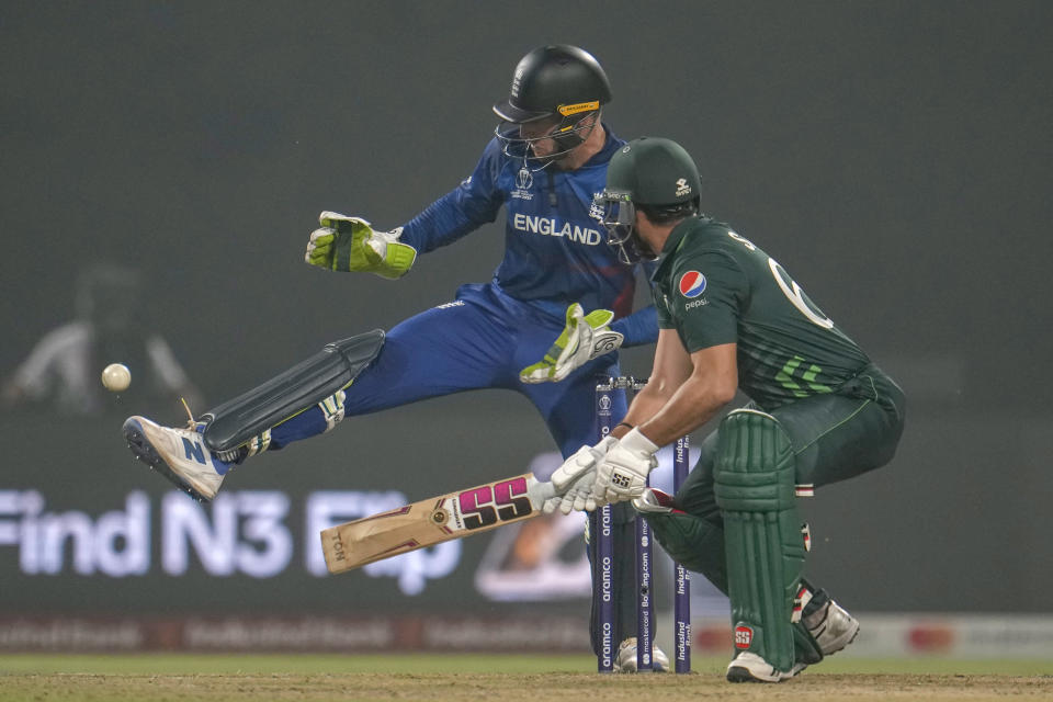England's captain and wicketkeeper Jos Butler tries to stop the ball with his shoes during the ICC Men's Cricket World Cup match between Pakistan and England in Kolkata, India, Saturday, Nov. 11, 2023. (AP Photo/Altaf Qadri)