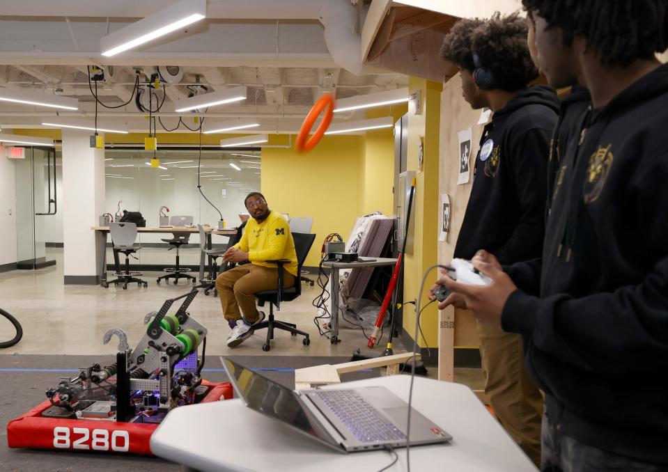 As FIRST Robotics students at Marygrove High School in Detroit drive and launch soft rings into a target, Parker Miles, a University of Michigan Ph.D. student, watches them on Wednesday, March 27, 2024.