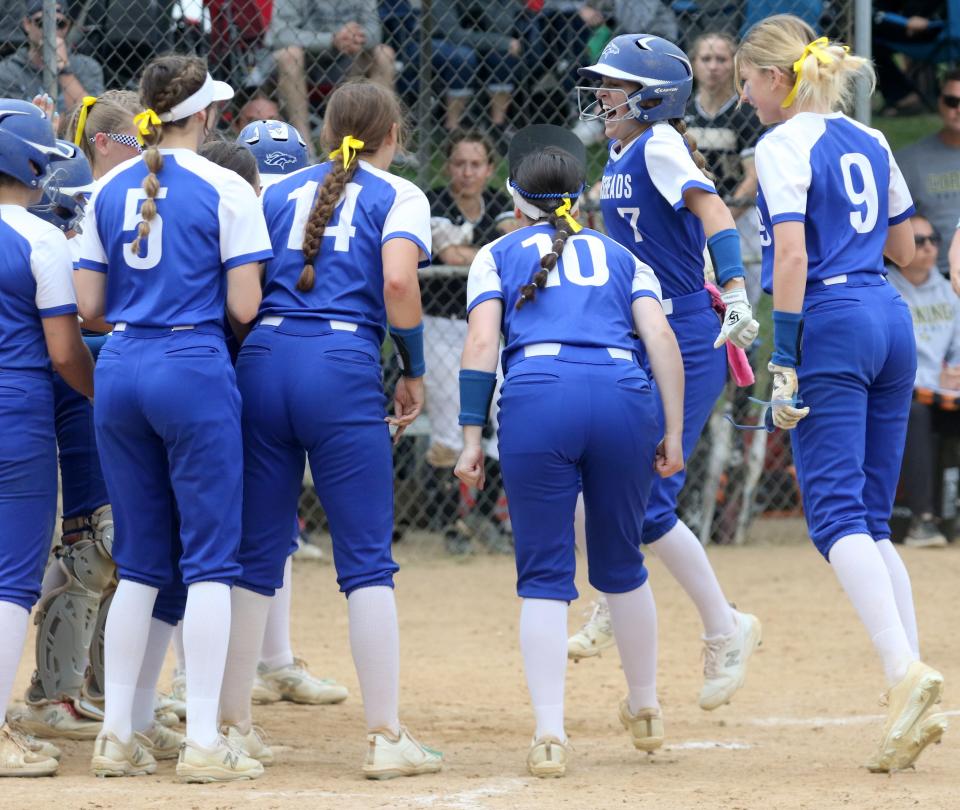 Horseheads' Megan Wolf is greeted by teammates at home plate after hitting the tying home run in a 7-5 win over Corning in the Section 4 Class AA softball championship game May 28, 2022 at the BAGSAI Complex in Binghamton.