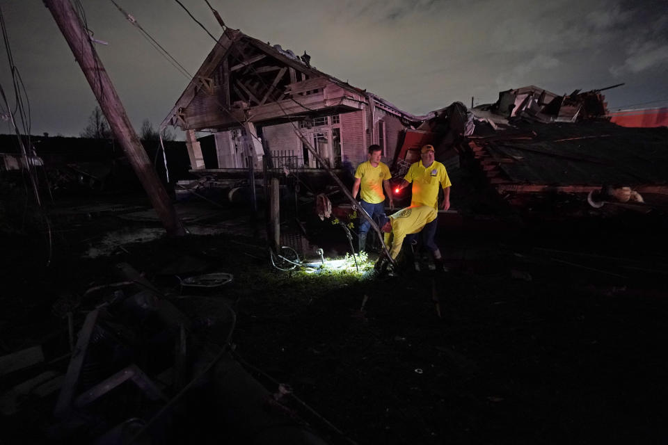 Responders work amidst debris after a tornado swept through the area in Arabi, La., Tuesday, March 22, 2022. A tornado tore through parts of New Orleans and its suburbs Tuesday night, ripping down power lines and scattering debris in a part of the city that had been heavily damaged by Hurricane Katrina 17 years ago. (AP Photo/Gerald Herbert)