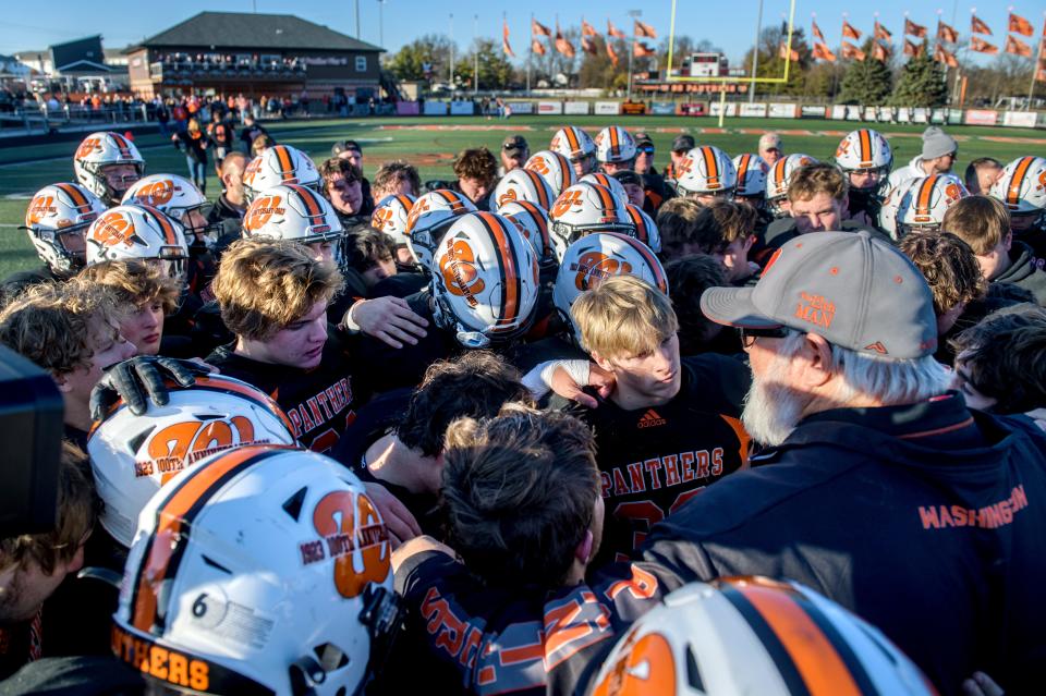 Washington head coach Darrell Crouch, far right, talks with his team after their 34-18 loss to the East St. Louis Flyers in the Class 6A football state semifinals Saturday, Nov. 18, 2023 at Babcook Field in Washington. The game capped the 19-year career of Crouch who announced his retirement before the start of the season.