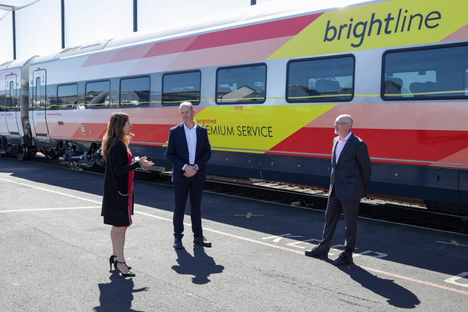 California State Treasurer Fiona Ma chats with Siemens Mobility Rolling Stock North America President Michael Cahill (middle) and Brightline CEO Michael Reininger (right) alongside a new train car in Sacramento.