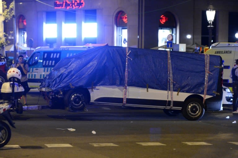 The white van which ploughed down Las Ramblas, killing 13, is towed away for further investigation
