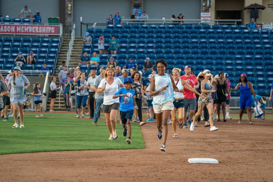 Fans rush the field on Sept. 19, 2022 for the first Diamond Dig that will be repeated on Saturday at Blue Wahoos Stadium.