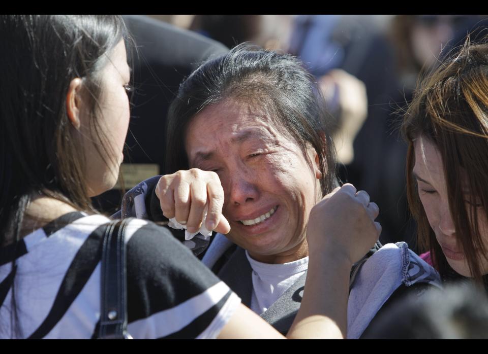 Panou Xiong, center, is comforted by family and friends following a Remembrance Ceremony commemorating the one-year anniversary of the worst mass shooting on a U.S. military base, where 13 people were killed and dozens wounded,, Nov. 5, 2010 in Fort Hood, Texas. Xiong's son, Pfc. Kham Xiong, was killed in the shooting.     <em><strong>CORRECTION:</strong> This slide originally said that the Fort Hood shooting took place in November 2010. The shooting took place in November 2009.</em>