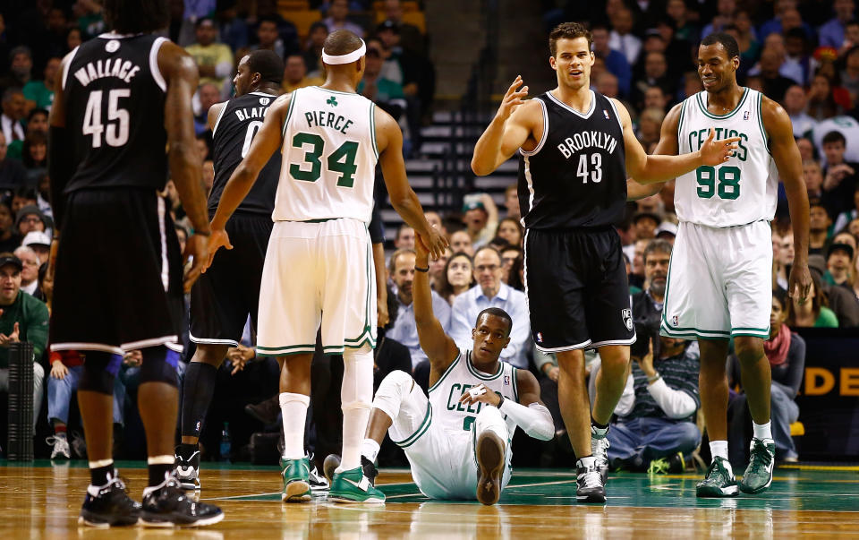 BOSTON, MA - NOVEMBER 28: Rajon Rondo #9 of the Boston Celtics is helped up by teammate Paul Pierce #34 after being fouled in front of Kris Humphries #43 of the Brooklyn Nets during the game on November 28, 2012 at TD Garden in Boston, Massachusetts. NOTE TO USER: User expressly acknowledges and agrees that, by downloading and or using this photograph, User is consenting to the terms and conditions of the Getty Images License Agreement. (Photo by Jared Wickerham/Getty Images)