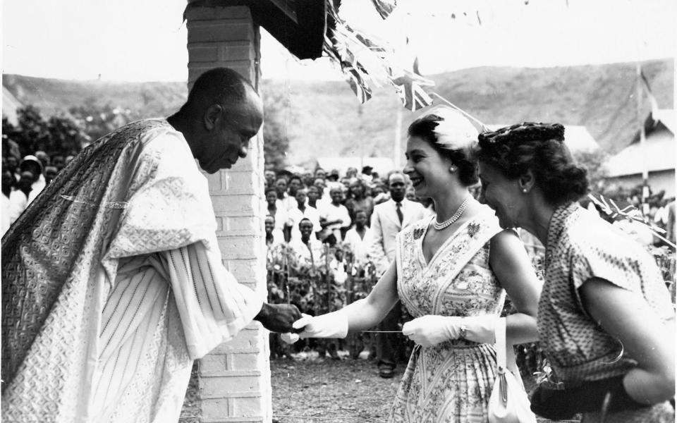 Queen Elizabeth II wore the brooches on either side of her dress during a royal visit to Nigeria in February 1956 - Getty 