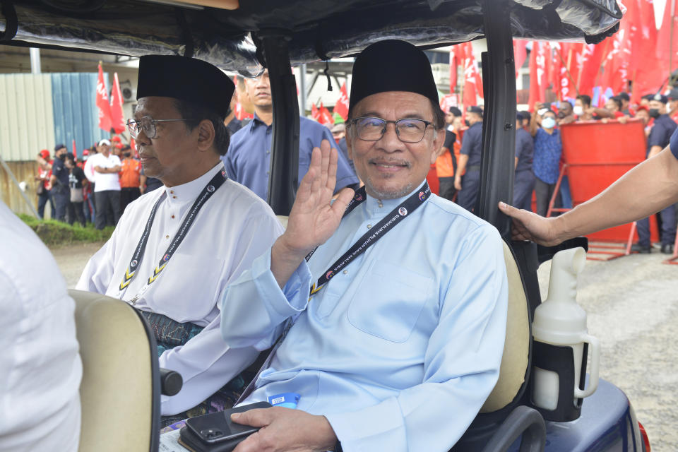 Malaysian opposition leader Anwar Ibrahim waves towards photographers after submitting his nomination papers at a nomination center for the upcoming general election in Tambun, Malaysia, Saturday, Nov. 5, 2022. Campaigning for Malaysia’s general elections formally started Saturday, in a highly competitive race that will see the world’s longest-serving coalition seeking to regain its dominance four years after a shocking electoral loss. (AP Photo/JohnShen Lee)