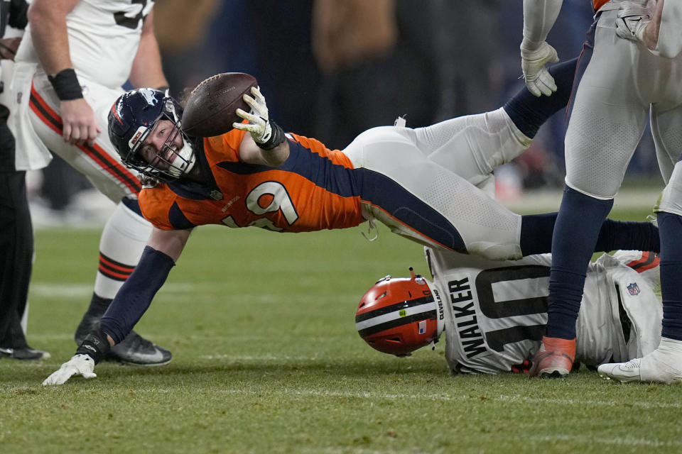 Denver Broncos linebacker Alex Singleton (49) recovers a fumble by Cleveland Browns quarterback PJ Walker (10) after Walker was sacked for a 9-yard loss during the second half of an NFL football game on Sunday, Nov. 26, 2023, in Denver. (AP Photo/Jack Dempsey)