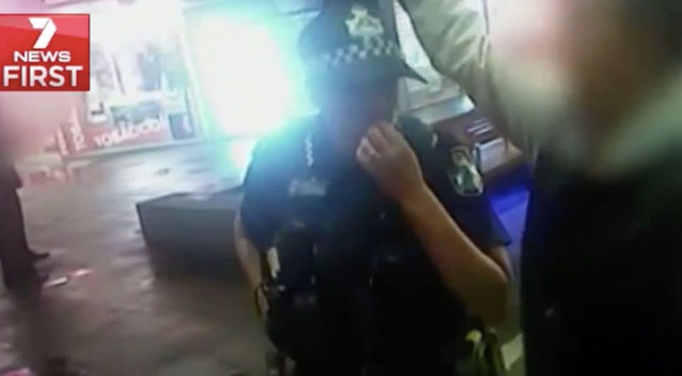 Footage shows a man casually pouring liquid over a female police officer's head. Photo: 7 News