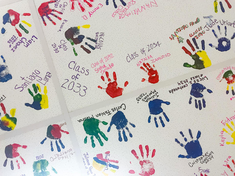 Elementary students at Calabasas School embellish school ceiling tiles with painted handprints to acknowledge academic achievement. (Jillian Kuhlmann/KnowledgeWorks)