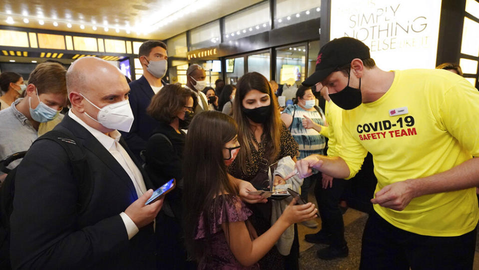 Theatergoers show proof of vaccination before a performance of “The Lion King” on Broadway, at the Minskoff Theatre, on Tuesday, Sept. 14, 2021, in New York. (Photo by Charles Sykes/Invision/AP) - Credit: Charles Sykes/Invision/AP