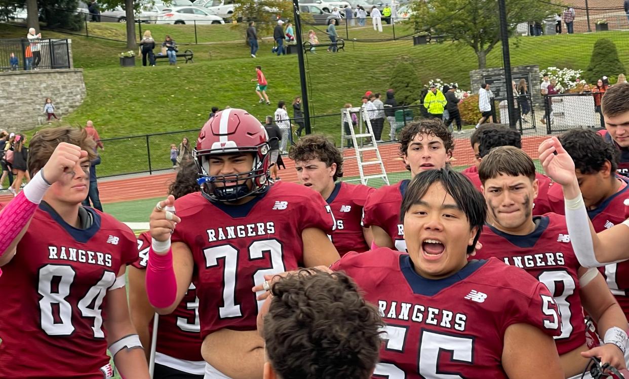 Westborough's Ivan Bardales Diaz (72) and William Zheng (55) lead the cheers after the Rangers defeated Fitchburg on Saturday, Oct. 14, 2023.