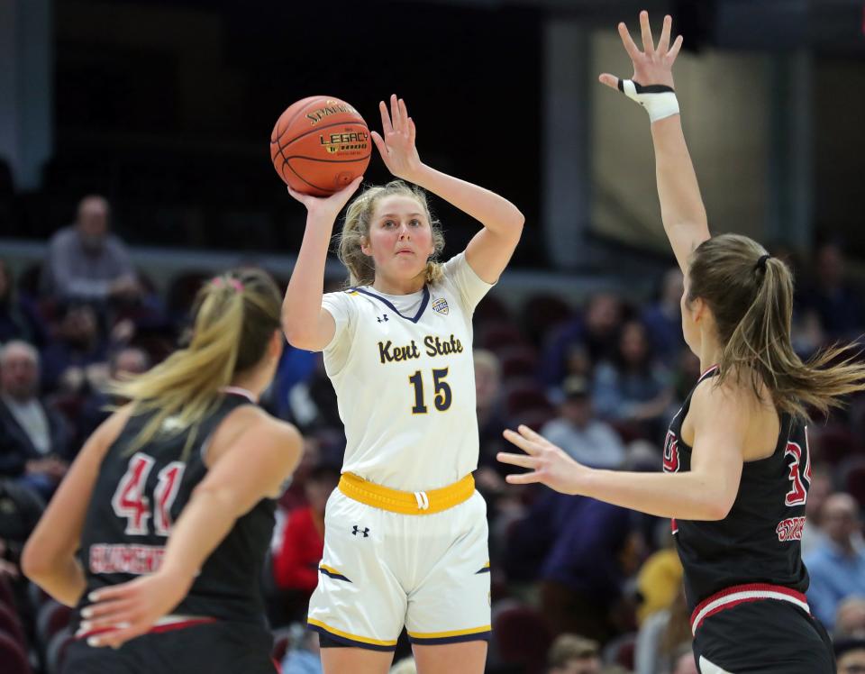 Kent State forward Bridget Dunn shoots between a pair of Northern Illinois defenders during the first half of the Mid-American Conference Tournament quarterfinals, Wednesday, March 13, 2024, in Cleveland.