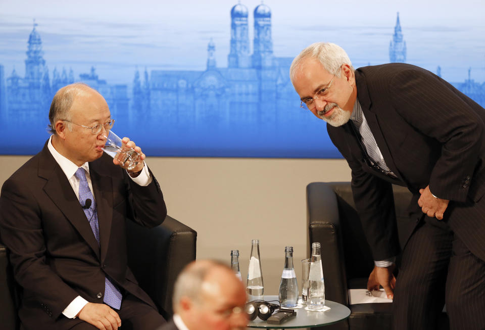 Iran's Foreign Minister Mohammad Javad Zarif, right, takes a seat next to Director General of the International Atomic Energy Agency, IAEA, Yukiya Amano, prior to a panel discussion at the 50th Security Conference on security policy in Munich, Germany, Sunday, Feb. 2, 2014. (AP Photo/Frank Augstein)