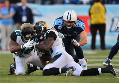 Nov 10, 2013; Nashville, TN, USA; Jacksonville Jaguars safety Johnathan Cyprien (37) recovers an onside kick against the Tennessee Titans during the second half at LP Field. The Jaguars beat the Titans 29-27. Mandatory Credit: Don McPeak-USA TODAY Sports