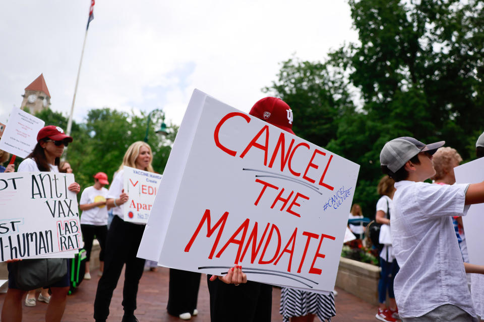 Protesters holding placards gather at Indiana University's Sample Gates during the demonstration on June 10, 2021.  / Credit: Jeremy Hogan/SOPA Images/LightRocket via Getty Images