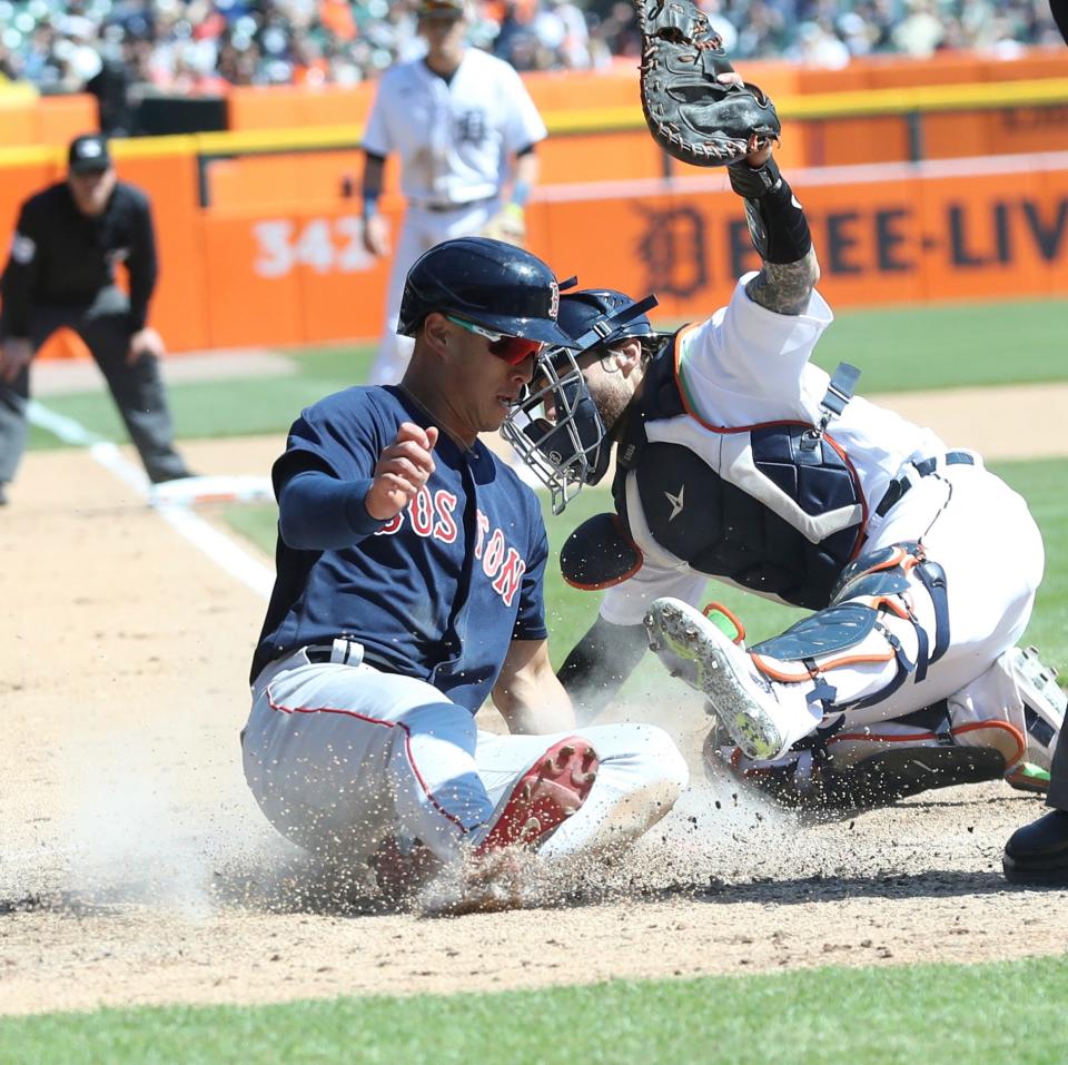 Boston Red Sox right fielder Rob Refsnyder (30) scores ahead of the tag by Detroit Tigers catcher Eric Haase (13) during seventh-inning action at Comerica Park in Detroit on Sunday, April 9, 2023.