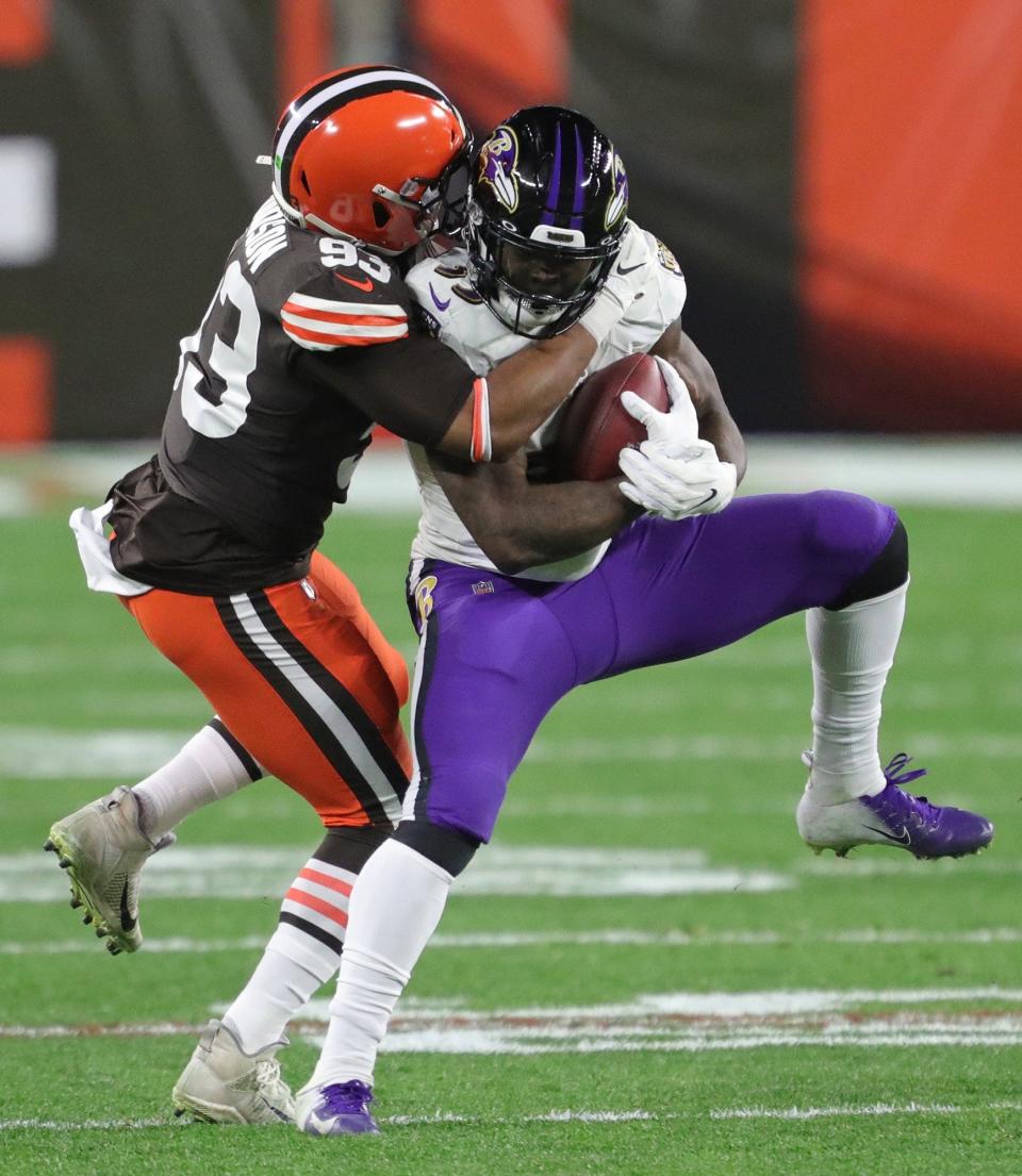 Cleveland Browns middle linebacker B.J. Goodson (93) brings down Baltimore Ravens running back Gus Edwards (35) after a reception on Dec. 14, 2020.