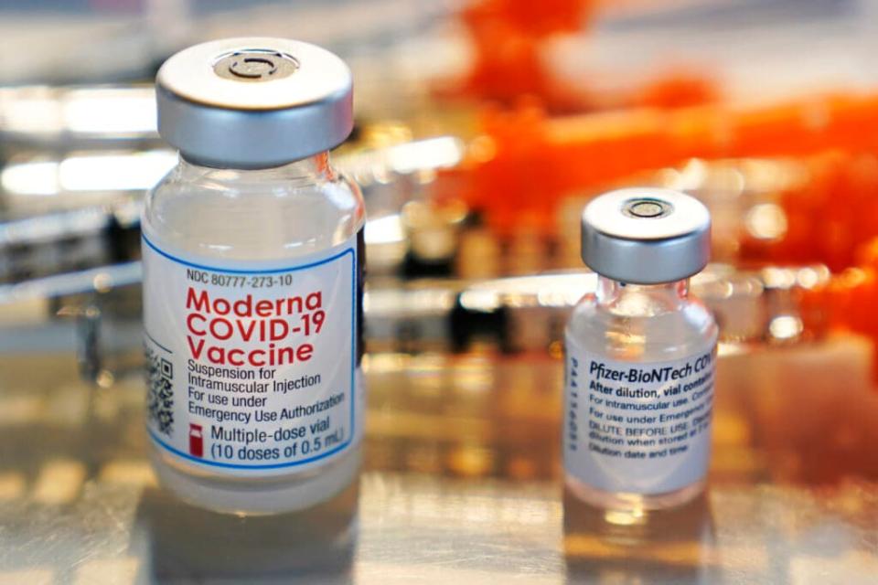 Vials for the Moderna and Pfizer COVID-19 vaccines are seen at a temporary clinic in Exeter, N.H. on Thursday, Feb. 25, 2021. (AP Photo/Charles Krupa, File)